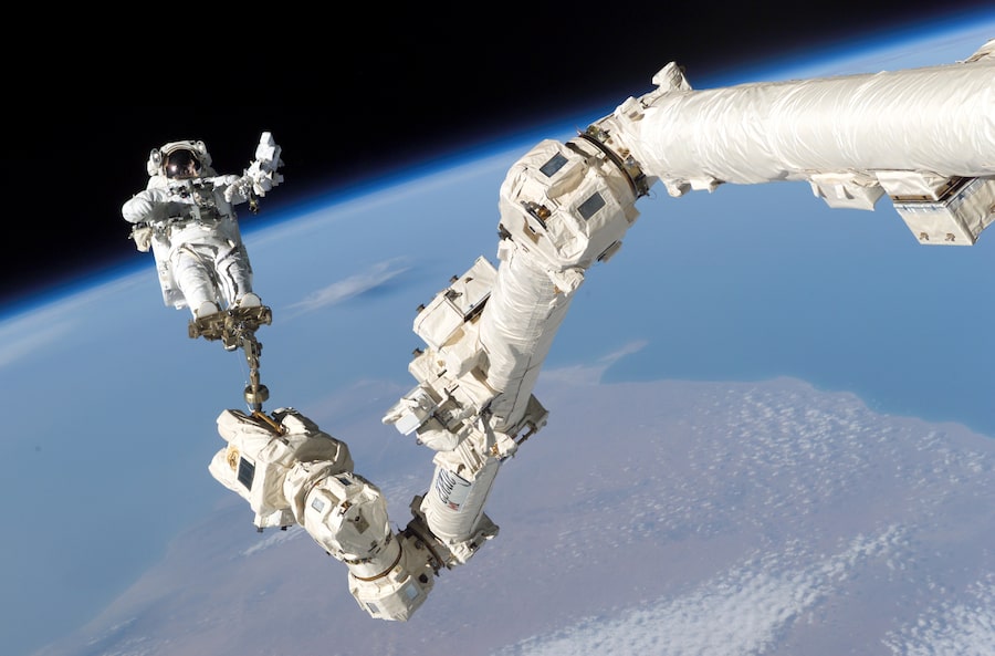 Mission STS-114 was known as 'The Return to Flight,' being the first shuttle launch since the Columbia tragedy. Among its many tasks, Canadarm2 assisted astronauts during their spacewalks. In this image, NASA astronaut Stephen Robinson is held aloft by Canadarm2 during the crew’s third spacewalk.