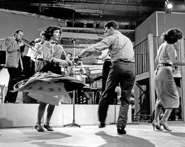 ONE-TIME USE ONLY WITH STORY SLUGGED NW-MIT-TODDLER-TRUCE-0215 -- A couple of Rock'n' Roll dancers jive on the set of the TV show 6.5 Special, 1957. The Six-Five Special burst onto television in the UK on Saturday evening, 16 February 1957. It was the first programme to fill the silent space in the schedules between six and seven - known as the toddler's truce – a time when parents could put their children to bed. Six-Five Special appealed to a young audience, and the Radio Times promised "plenty of music, in the modern manner, with rock’n’roll, skiffle groups, traditional jazz, featuring top music groups and soloists". The show was originally scheduled for just six weeks, but its success led to a two year run. (Photo by Richi Howell/Redferns)