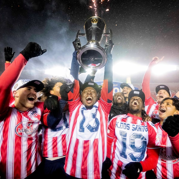 Atlético Ottawa's Ballou Tabla raises the North Star Cup following the team’s victory over Cavalry FC in extra time during the Canadian Premier League final in Ottawa, on Nov. 9.