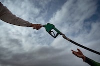 Fishermen in Hagonoy, Philippines, buy fuel at a riverside gas station on March 9. 