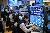 Traders work on the floor of the New York Stock Exchange (NYSE) in New York on July 23, 2026. Wall Street stocks tumbled on Thursday as oil prices shot higher on worsening effects of the US-Iran war while Tesla and Google parent Alphabet fell sharply after earnings reports.  International oil benchmark Brent North Sea crude topped $100 a barrel after Yemen's Iran-backed Houthi rebels struck oil tankers in the Red Sea. The attack brought the war roiling the Middle East to a new front. (Photo by ANGELA WEISS / AFP via Getty Images)