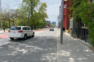 Cars merge into the right lane ahead of the new priority transit lane on Bathurst Street, just south of Dundas Street in Toronto on May 22, 2026. Experts say using the zipper method can help everyone move faster.