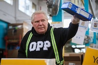 Ontario Premier Doug Ford helps pack and sort food donations at the Daily Bread Food Bank’s spring public food sort in Toronto, on Saturday, April 4, 2026. THE CANADIAN PRESS/Sammy Kogan