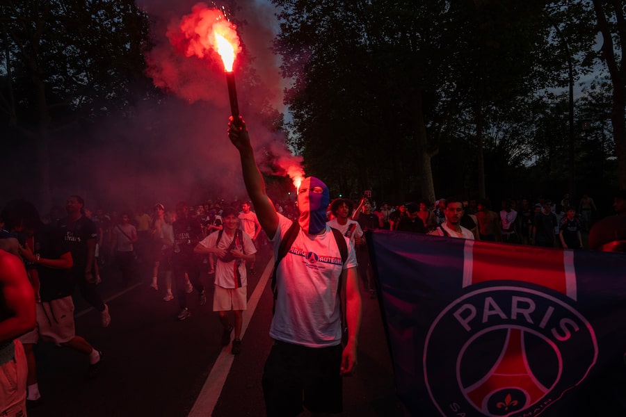 Paris Saint-Germain fans celebrate their team's victory over Arsenal in the UEFA Champions League final, near the Parc des Princes stadium in Paris on Saturday.