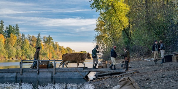 FIRST COW (2020). In the latest from writer-director Kelly Reichardt (Certain Women), a taciturn cook (John Magaro) and a Chinese immigrant (Orion Lee) in 19th-century Oregon Territory team up for a business venture that depends on the participation of a wealthy landowner’s prized milking cow. Courtesy of TIFF
