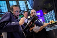 FILE PHOTO: Traders work on the floor at the New York Stock Exchange (NYSE) in New York City, U.S., July 3, 2024.  REUTERS/Brendan McDermid/File Photo