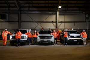 Members of the systems operations group at Hydro Ottawa stand next to the electric vehicle fleet.