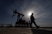 An oil and gas industry worker walks during operations of a drilling rig at Zhetybay field in the Mangystau region, Kazakhstan, November 13, 2023.  