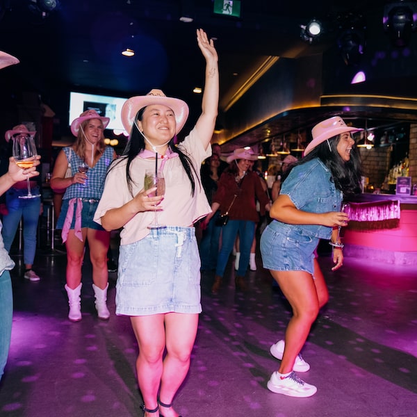 Attendees dance at a Dolly Parton tribute night at Dolly’s Country Bar on The Esplanade in Toronto on Sept. 10.