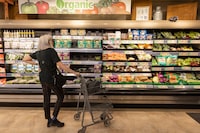 A customers looking at the organic shelfs in Farm Boy grocery stores on Bathurst , Toronto, photographed on May 31, 2023 ( 