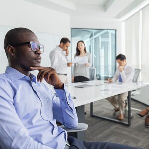 Businessman thinking during meeting in office