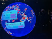 A LED sphere screen shows information inside the new location of the prediction market online platform Polymarket called "The Situation Room", during its opening day in Washington, DC, on March 20, 2026. Prediction market platforms have rapidly broken into the mainstream in the United States, positioning themselves as an alternative to both traditional polling and licensed sports betting. Platforms like Polymarket and its biggest rival Kalshi, remain illegal or unregulated in most countries outside the US, where regulators have generally classified them as unlicensed gambling. (Photo by Théo MARIE-COURTOIS / AFP via Getty Images)