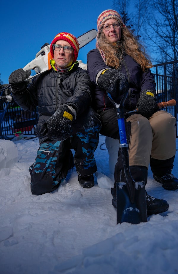 Dawn Detarando and Brian McArthur pose next to their sculpture, The Industrious Beaver: Environmental Superhero, in Banff, Alta., in January. The pair have sculpted snow across the country for more than two decades.