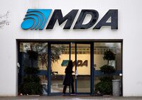A woman enters the offices of MacDonald, Dettwiler and Associates in Richmond, B.C., Tuesday, January 8, 2008. MDA is selling its space missions and satellite business to Alliant Techsystems. THE CANADIAN PRESS/Richard Lam 