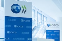 This photograph taken on September 22, 2025 shows the logo of the Organisation for Economic Cooperation and Development (OECD) displayed on banners at the OECD headquarters in Paris. Wealthy countries topped their $100 billion annual climate finance goal for poorer countries in 2023 and 2024, the OECD said on May 21, 2026, marking three straight years of meeting the target. After providing $115.9 billion in 2022, wealthy countries sharply raised their contribution to $132.8 billion in 2023 and delivered $136.7 billion in 2024, according to the Organisation for Economic Cooperation and Development, which tracks the figures. (Photo by JOEL SAGET / AFP via Getty Images)