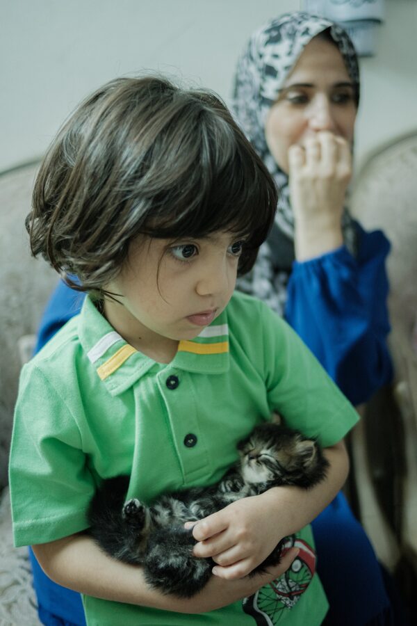 Nama Soliman fled Gaza with her nine children, including Joury, left, and Remas, right. The family now lives in Cairo with her husband Maher, in a three-room apartment. 