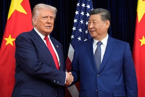 In this file photo, President Donald Trump and Chinese President Xi Jinping shake hands before their meeting in Busan, South Korea, in October, 2025.