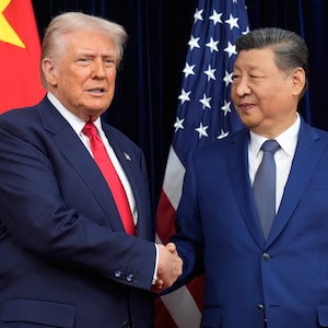 In this file photo, President Donald Trump and Chinese President Xi Jinping shake hands before their meeting in Busan, South Korea, in October, 2025.