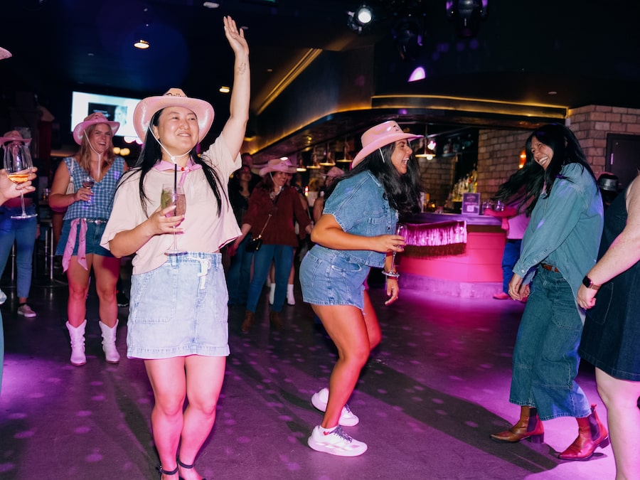 Attendees dance at a Dolly Parton tribute night at Dolly’s, a country bar on The Esplanade in Toronto, on Sept. 10.