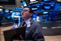 Traders work on the floor of the New York Stock Exchange (NYSE) on August 14.