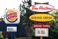 Burger King and Tim Hortons signs are displayed on St. Laurent Boulevard in Ottawa on August 25, 2014. 