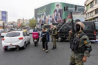 TEHRAN, IRAN - MARCH 10: A police officer stands guard beneath a poster of Iran's former leader, Ayatollah Ali Khamenei on March 10, 2026 in Tehran, Iran. The United States and Israel continued their joint attack on Iran that began on February 28. Iran retaliated by firing waves of missiles and drones at Israel, and targeting U.S. allies in the region. (Photo by Majid Saeedi/Getty Images)