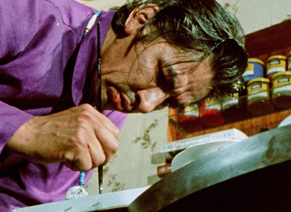 THERE ARE NO FAKES (Documentary, 2018). Pictured: Norval Morrisseau in the 1970s from a National Film Board production. After spending $20,000 at a reputable Toronto gallery to purchase Spirit Energy of Mother Earth, Kevin Hearn (of the Barenaked Ladies) was surprised to discover the authenticity of his Morrisseau canvas being called into question. His decision to sue the art dealer spurs an investigation into the painting's provenance, and so begins the unravelling of an art fraud ring with fighting factions, all claiming to be the true protectors of the Anishinaabe painter's legacy—and all of whom happen to be white.  Credit: National Film Board of Canada / Cave 7 Productions Inc.