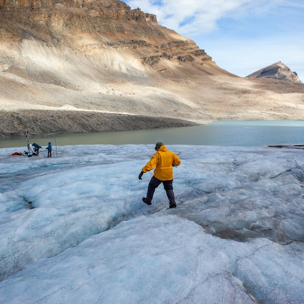 John Pomeroy walks across Peyto Glacier in Alberta on Sept. 4, 2024. The hydrologist has studied this glacier since 2008, documenting it as it melts.