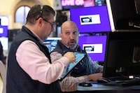 FILE PHOTO: Traders work on the floor at the New York Stock Exchange (NYSE) in New York City, U.S., April 8, 2026. REUTERS/Brendan McDermid/File Photo