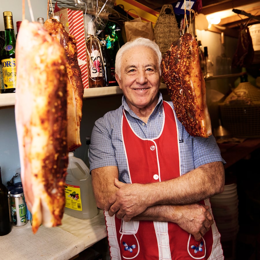 Giuseppe Pacienza in the cold room in his home in Brampton, Ont., where he hangs cuts of pork to cure and stores canned goods he makes himself.