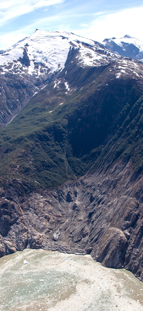 Three days before a survey team took this photo in Alaska’s Tracy Arm, a tsunami – triggered by a landslide on the other side of the fjord – stripped away the vegetation on the slopes at middle.