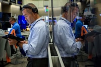 FILE PHOTO: Futures-options traders work on the floor at the New York Stock Exchange's NYSE American (AMEX) in New York City, U.S. July 16, 2026.  REUTERS/Brendan McDermid/File Photo