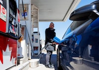 A customer pumps gas as a gas station in Ottawa on Monday. Gas prices surged 21.2 per cent in March from February.