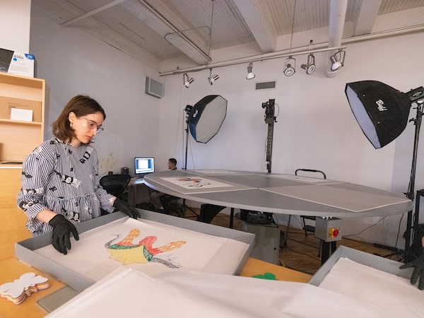 Daria Murphy, Digitization Project Specialist at The Burtynsky Studio loads prints by Kenojuak Ashevak into the digitizer. Toronto, ON