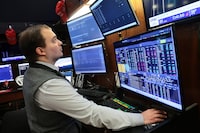Traders work on the floor of the New York Stock Exchange during morning trading on April 20.