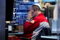 FILE PHOTO: A trader works on the floor at the New York Stock Exchange (NYSE) in New York City, U.S., January 13, 2026. REUTERS/Brendan McDermid/File Photo