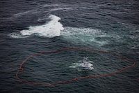 An oil spill containment boom surrounds the Nathan E. Stewart tugboat in the Seaforth Channel near Bella Bella, B.C., in November, 2016. 