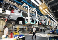 Honda employees work along the vehicle assembly line before an event announcing plans for a Honda electric vehicle battery plant in Alliston, Ont., on Thursday, April 25, 2024. THE CANADIAN PRESS/Nathan Denette