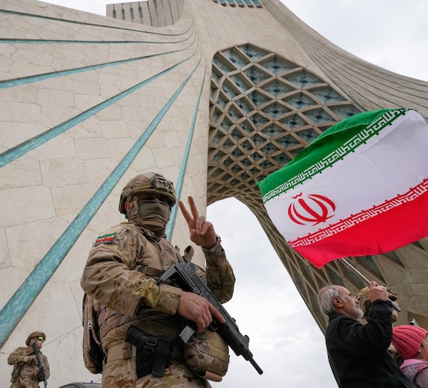 A Revolutionary Guard member patrols the Azadi monument in Tehran on Feb. 11 during anniversary celebrations of Iran's 1979 revolution. Two weeks later, Iran would be under U.S. and Israeli missile fire that killed Iran's Supreme Leader, who the guard answers to directly.