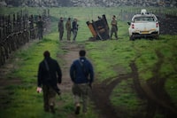 Israeli soldiers stand next to a fragment of a missile fired from Iran in the Israeli-controlled Golan Heights on Thursday.