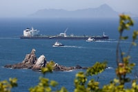 Tugboats guide the crude oil tanker Odessa, carrying UAE crude after passing through the Strait of Hormuz with its Automatic Identification System transponder turned off, navigates the waters at Daesan port, where it is expected to discharge crude oil, in Seosan, South Korea, May 8, 2026. REUTERS/Kim Soo-hyeon