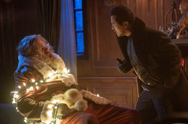 (from left) David Harbour and John Leguizamo as Scrooge in Violent Night.