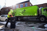 A Green For Life truck and workers collect recycling outside homes in Toronto, Tuesday, January 20, 2026.