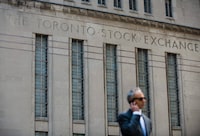 A man walks past a building in Toronto that used to house the Toronto Stock Exchange on Thursday, Aug. 18 2011.  