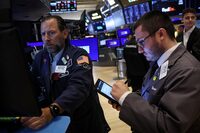 Traders work on the floor at the New York Stock Exchange (NYSE) in New York City, U.S., June 24, 2024.  REUTERS/Brendan McDermid/File photo