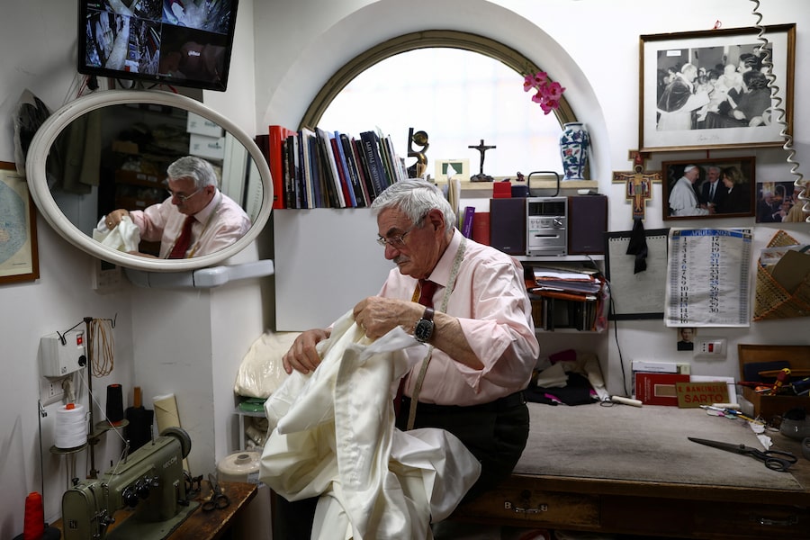Raniero Mancinelli makes a papal cassock at his tailor shop in Borgo, not far from the Vatican, whose clerics have worn his handcrafted goods for decades.