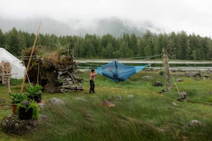 Annie Lax swings her friend on a hammock during Robinson Cook’s birthday party on Calf Island on June 11, 2024. Mr. Cook lives on the small island that’s a short boat ride from Tofino with his partner, Mary Forest.
