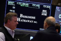 FILE PHOTO: A screen displays the trading information for Berkshire Hathaway inc. as traders work on the floor at the New York Stock Exchange (NYSE) in New York City, U.S., October 22, 2025.  REUTERS/Brendan McDermid/File Photo
