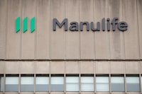 Signage is seen on Manulife Financial Corp.'s office tower in Toronto, Tuesday, Feb. 11, 2020. THE CANADIAN PRESS/Cole Burston