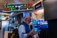 People work on the floor of the New York Stock Exchange (NYSE) on July 07, 2026 in New York City.  